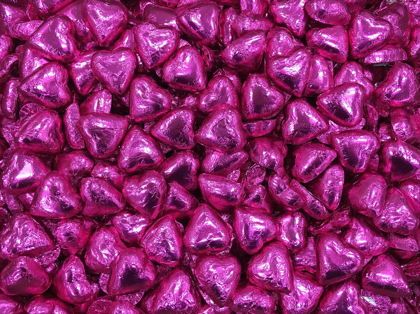 Toms Choc Hearts 1kg hot pink foiled in cello bag